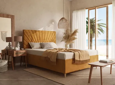A bedroom scene with a bed, nightstand, and a large window overlooking a beach.