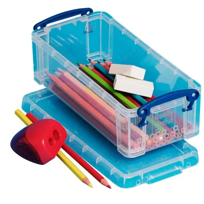 A clear studio shot of a set of transparent storage boxes filled with colored pencils and erasers, along with a pencil sharpener and loose pencils.