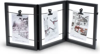 A black, tri-fold photo frame with wires and clips holding three small photos.