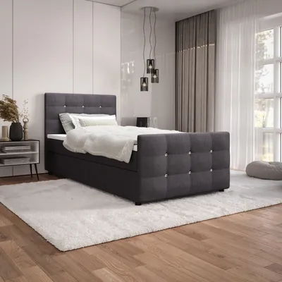 A bedroom scene with a bed, nightstand, and rug.