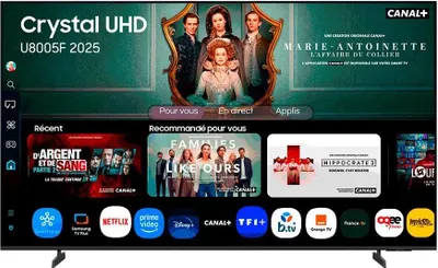 A Samsung TV displaying a streaming service interface with various show posters and app icons.