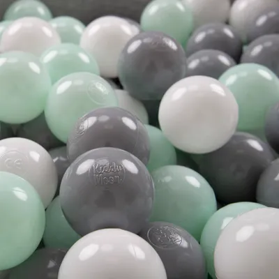 A close-up view of many colorful balls in a ball pit.