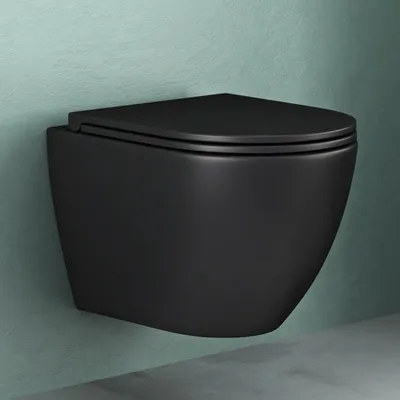 A black wall-mounted toilet against a light green textured wall and a gray floor.