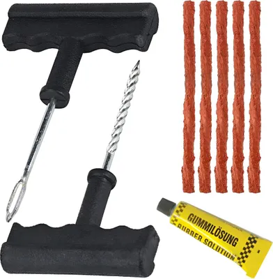 A tire repair kit with tools and repair strings.