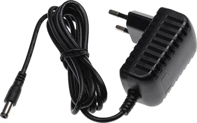 A black power adapter with a coiled cable and a DC barrel connector, isolated on a white background.