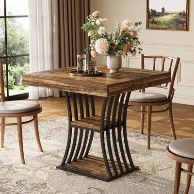 A dining table set in a dining room with chairs and a vase of flowers.