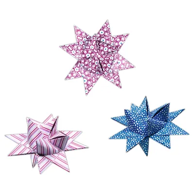 Three origami stars made of paper strips, arranged on a white background.