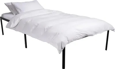 A white duvet and pillow on a black metal bed frame against a white background.