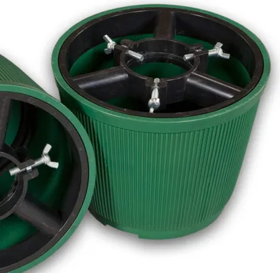 Two green Christmas tree stands are shown against a white background.