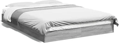 A modern, low-profile bed frame with a gray wood-grain finish, dressed with white bedding and a decorative gray runner.
