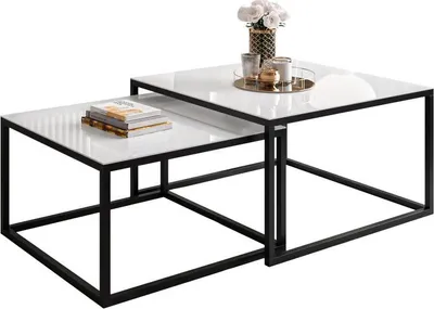 A set of two nesting coffee tables with white marble-like tops and black metal frames, displayed on a white background.