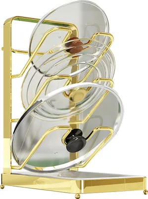 A gold-colored pot lid organizer holding several glass pot lids.