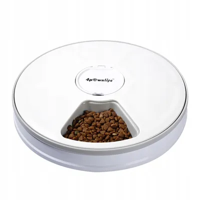 A white automatic pet feeder with a gray rim, filled with brown kibble in one of its compartments.