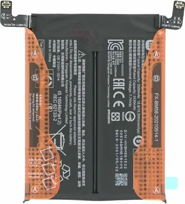 A flat lay of a black smartphone battery with orange protective covers.