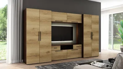 A modern entertainment center with wooden cabinets and a large TV.