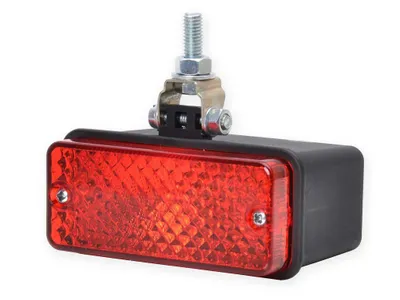 A red and black automotive light with a silver mounting bracket and bolt, isolated on a white background.