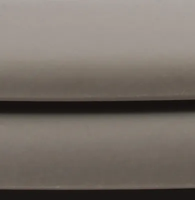 A close-up, abstract view of a toilet seat.