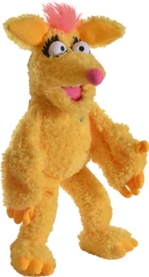 A yellow plush puppet with pink hair and large eyes stands against a white background.