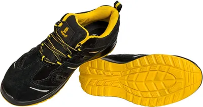 A pair of black and yellow work shoes are displayed against a white background. One shoe is shown from the side, and the sole of the other shoe is visible.