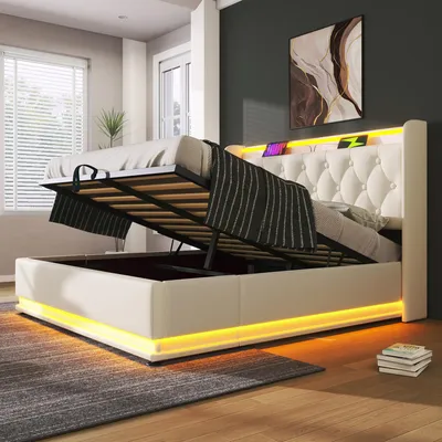 A modern bedroom with a white upholstered bed frame featuring LED lighting.