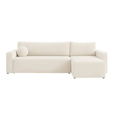 A cream-colored sectional sofa with a round pillow on a white background.