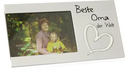 A white photo frame with a picture of a woman and a child inside, and text and a heart design on the frame.