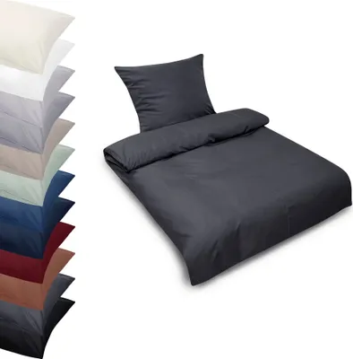 A stack of folded bedding in various colors and a single bedding set in dark gray.