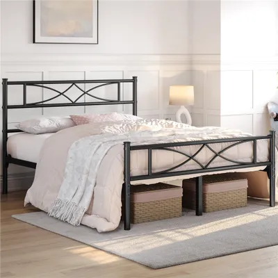 A bedroom scene featuring a black metal bed frame with bedding and storage baskets underneath.