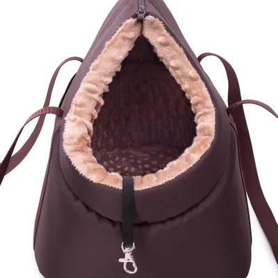 A close-up view of the opening of a brown pet carrier bag with a tan, fuzzy lining.