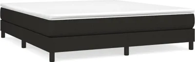 A studio shot of a black boxspring bed frame with a white mattress on top, set against a white background.