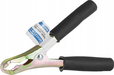 A close-up shot of a battery clamp with a label attached.
