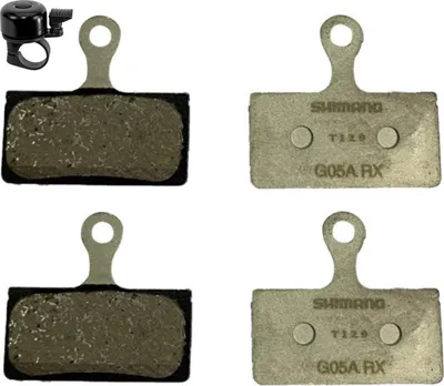 Zdjęcie produktu dla maxxi4you 2 pary klocków hamulcowych Shimano do rowerów typu G G05A wraz z dzwonkiem rowerowym maxxi4you