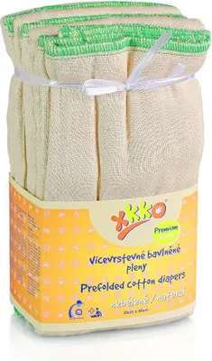 A pack of prefolded cotton diapers with green trim, tied with a white ribbon, sitting in its packaging.
