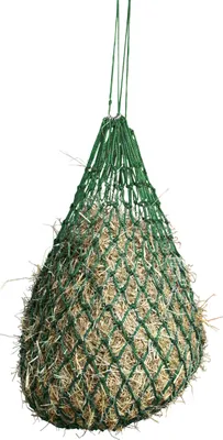 A green hay net filled with hay, suspended from above.