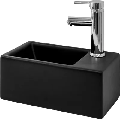 A black ceramic sink with a chrome faucet against a white background.