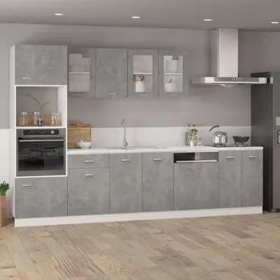 A modern kitchen with gray cabinets and a white countertop.