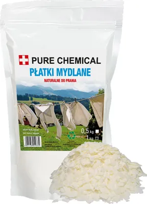 A bag of soap flakes with a pile of flakes in front of it, with a mountain landscape in the background.