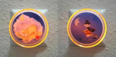 Two night lights plugged into a wall.