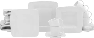 A collection of white porcelain dinnerware, including plates and cups, arranged on a white background.