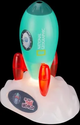 A teal rocket-shaped projector with red fins sits on a white cloud-like base, with a black background.