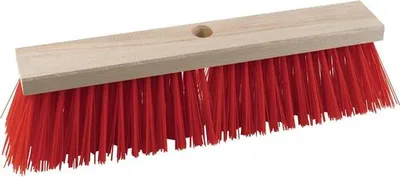 A close-up studio shot of a broom head with red bristles and a wooden handle.
