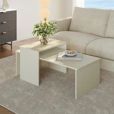 A living room scene with a sofa, a side cabinet, and nesting coffee tables.