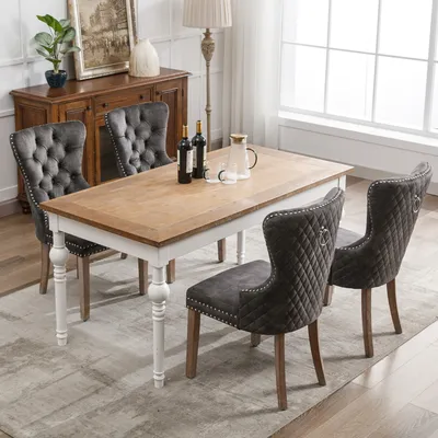 A dining room scene with a table and chairs.