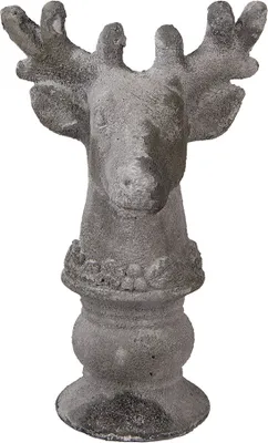 A stone sculpture of a deer's head on a pedestal.
