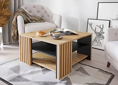 A coffee table is shown in a living room setting with a chair and a sofa.