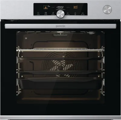 A front view of a built-in oven with the door open, showing the interior and control panel.