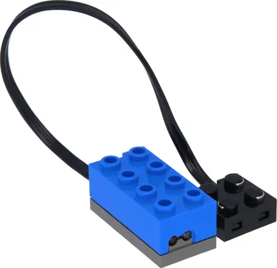 A LEGO light sensor module with a black cable connecting two LEGO bricks, one blue and one black, against a white background.