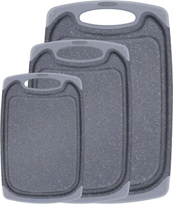 Three gray cutting boards of different sizes are arranged diagonally.