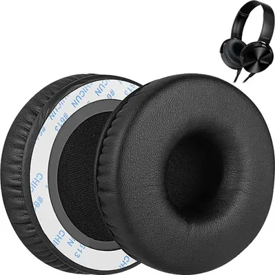 A pair of black ear pads for headphones, with a pair of black headphones in the background.