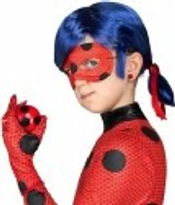 A child wearing a Ladybug costume, holding a toy ladybug.